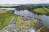 an aerial view of the abbey ruins, current and past graveyard, and the estuary.