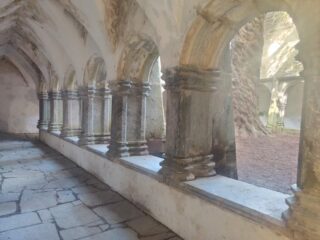 the arched cloisters of the abbey