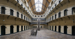 a wide view of the 3 levels of prison cells in a pan-optican prison wing