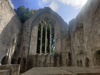 view of a wall of the church, with the open arches of the window.