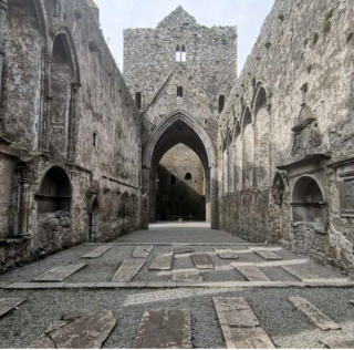 image of the church ruins, with grave markings lying across the ground