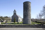 the small round tower in the foreground, with a modern church behind it.