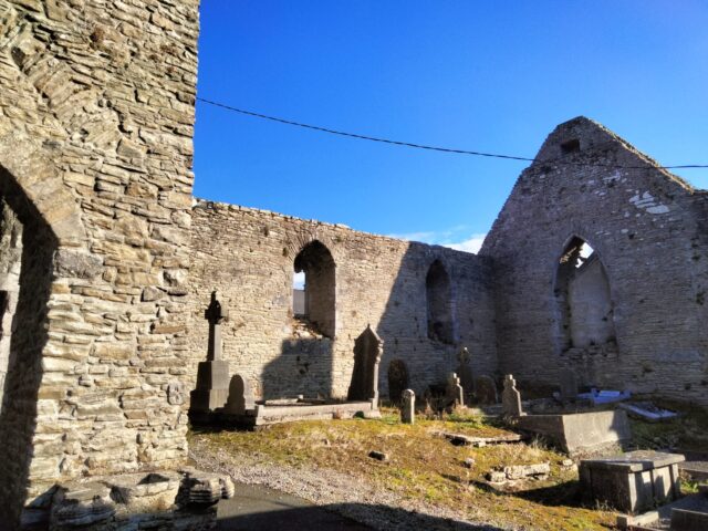 church ruins with gravestones among the grounds