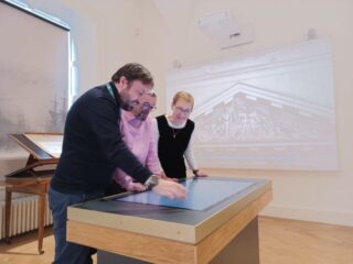 2 people receive a guided tour at the custom house