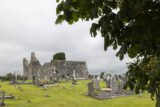 view of the church ruins, with grave-markers in the grounds surrounding it.