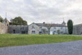 exterior of the two-storey cottage built into the bawn wall of the Castle