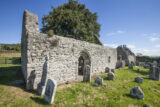 exterior of the church with gravestones dotted outside it.