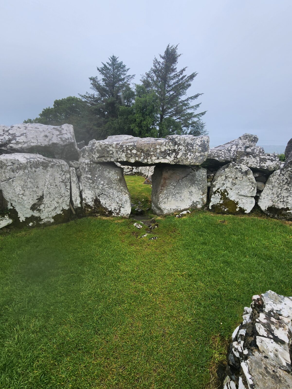 a stone tomb surrounded by other stones on either side
