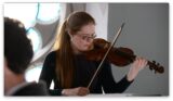 Caitríona O'Mahony plays the fiddle dressed in black