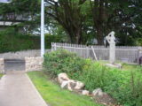 the cross stands in a small fenced off area