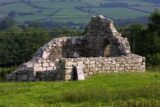 The roofless ruins of a small church in a field
