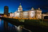 The Custom House at night time lit up.
