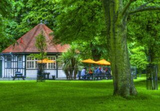 Side view of Phoenix Park Tearooms with lots of diners enjoying refreshments Al Fresco