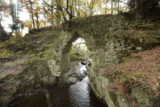 view of a cobbled stone bridge, with trees surrounding it