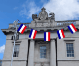 French flags in front of the Custom House