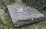 a large slab of stone lying flat on the ground