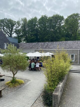 People seated under parasols dining al Fresco.
