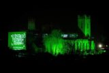 a church building lit up in green to celebrate saint patrick's day