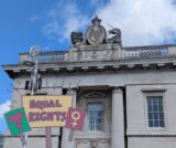 Exterior view of Custom House with Equal Rights emblems