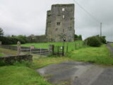 exterior view of the castle ruins behind gates