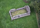 aerial view of the roofless ruins of a small church