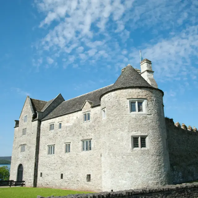 Exterior of the stone castle, which looks more like a large manor house.