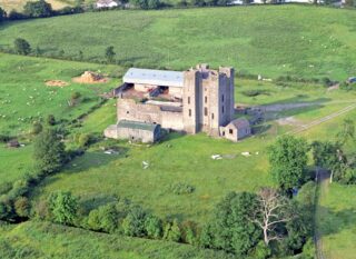 an aerial view of the castle with the farm surrounding it