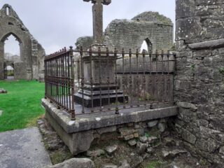 view of a part of the ruined abbey, and a cross