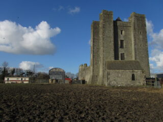 the tower castle with a farm beside it