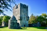 Aughnanure Castle view from the east under a bright blue sky