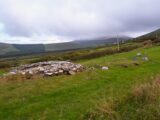 the ruins of the monastic site nestled amongst the valley of hills.