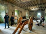 Basement tour of Castle with an old cannon machine and tour participants