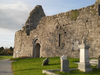 the remains of the roofless church within a graveyard