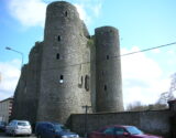 a tall, twin-towered castle within a town