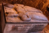 a stone tomb with carvings of two people on the top