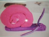 A snail made from pink and purple slime