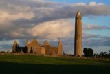 Kilmacduagh round tower and churches in the sunset