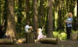 Children in an outdoor classroom in the woods at JFK
