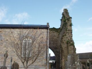partial view of the original church ruins, with the new church build now beside it.