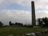 view of the round tower and church ruins backdropped by a dusky sky.