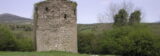 the round tower keep backdropped by the distant mountains