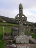 a high cross at Kilkieran backdropped by the hills and houses