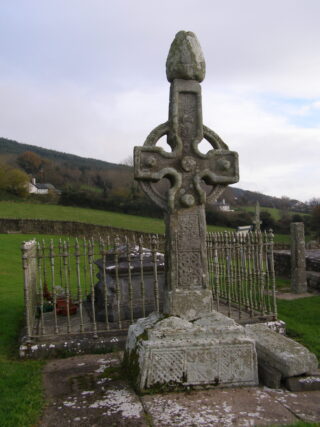 a high cross at Kilkieran backdropped by the hills and houses