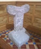 a small cross standing on decorated tiles