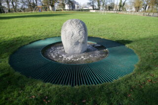 the decorated stone standing within a rounded slot outside