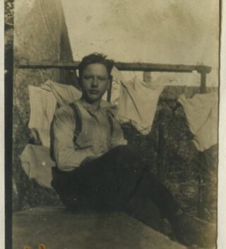 A man sits in a prison cell.
