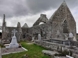 the church ruins with graves beside it