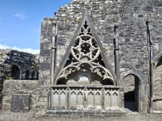 a tomb, with a decorated canopy above it.