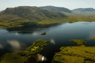 aerial view of the surrounding landscape of clear water and mountains
