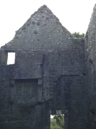 the windowless walls of the friary